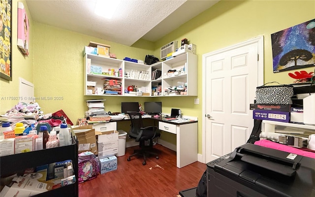 office area with dark wood-style floors and a textured ceiling