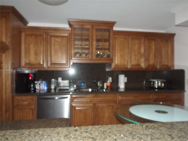 kitchen with dishwasher, brown cabinetry, and a sink
