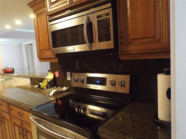 kitchen featuring crown molding, brown cabinets, stainless steel appliances, backsplash, and recessed lighting