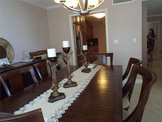 dining room with ornamental molding, tile patterned floors, and visible vents