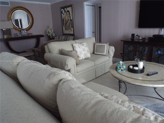 tiled living area featuring ornamental molding and visible vents