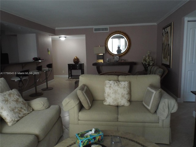 tiled living room with baseboards, visible vents, and ornamental molding