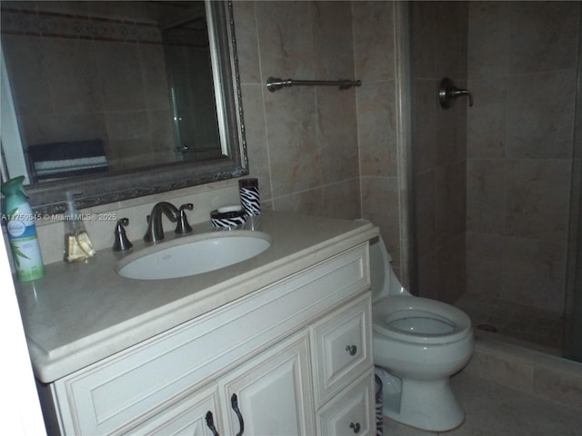 full bathroom featuring a shower stall, tile walls, vanity, and toilet