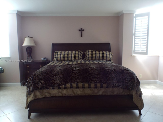 bedroom featuring light tile patterned flooring, baseboards, and ornamental molding