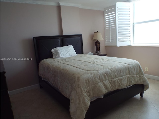 bedroom with tile patterned floors, baseboards, and crown molding