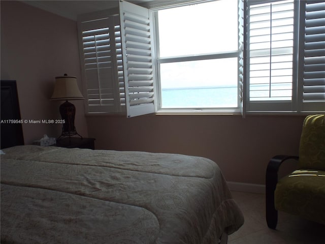 bedroom with tile patterned flooring and baseboards