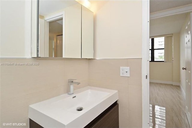 bathroom with tile walls and vanity