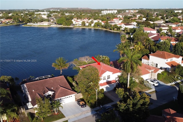 drone / aerial view with a water view and a residential view