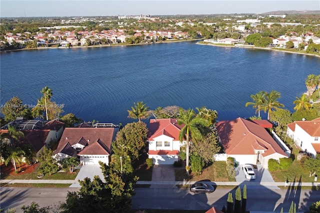 drone / aerial view with a water view and a residential view