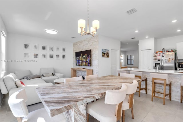 dining room with an inviting chandelier, light tile patterned floors, visible vents, and recessed lighting