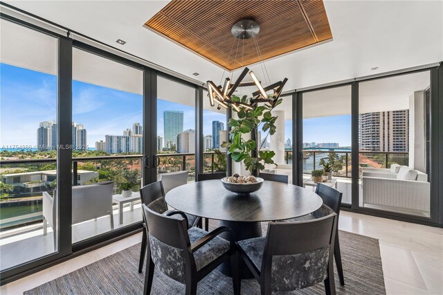 19667 Turnberry Way Unit 8K, Aventura, FL 33180 - sunroom / solarium featuring a chandelier, a city view, and french doors