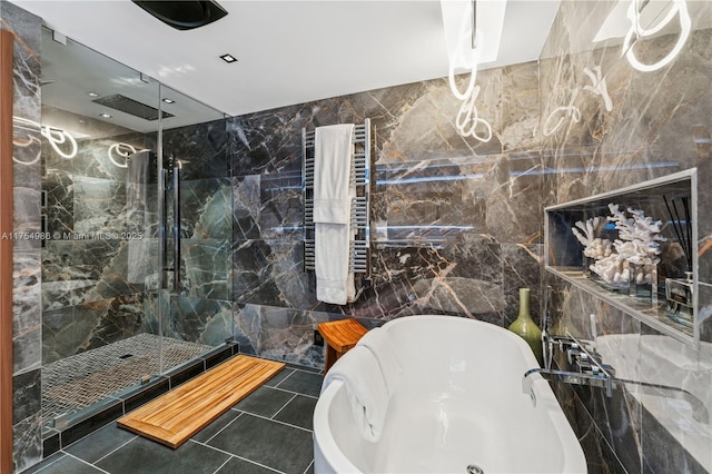 19667 Turnberry Way Unit 8K, Aventura, FL 33180 - bathroom featuring radiator, tiled shower, a freestanding tub, and tile walls