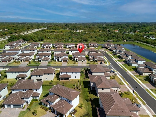 bird's eye view with a residential view and a water view