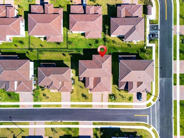 birds eye view of property with a residential view