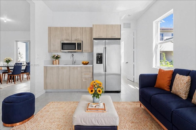 living area with light tile patterned floors and visible vents