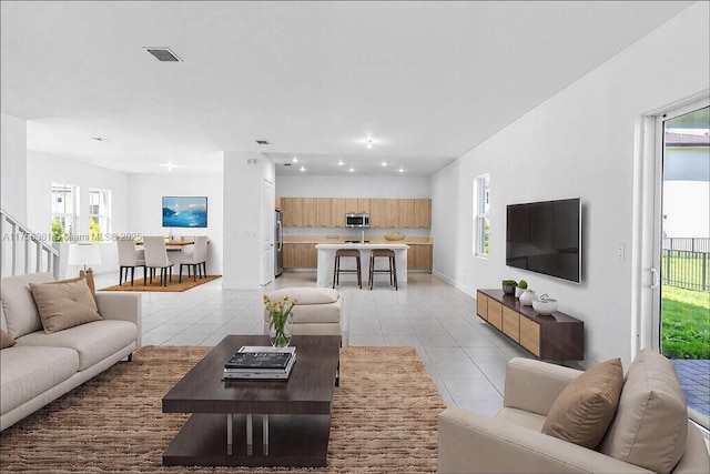 living area with recessed lighting, light tile patterned flooring, baseboards, and visible vents