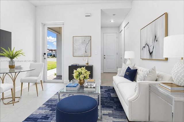 living room featuring light tile patterned floors and baseboards