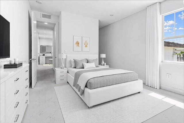 bedroom with visible vents and concrete flooring