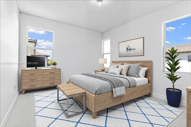 bedroom featuring multiple windows and baseboards