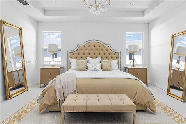 bedroom featuring a tray ceiling, multiple windows, and baseboards