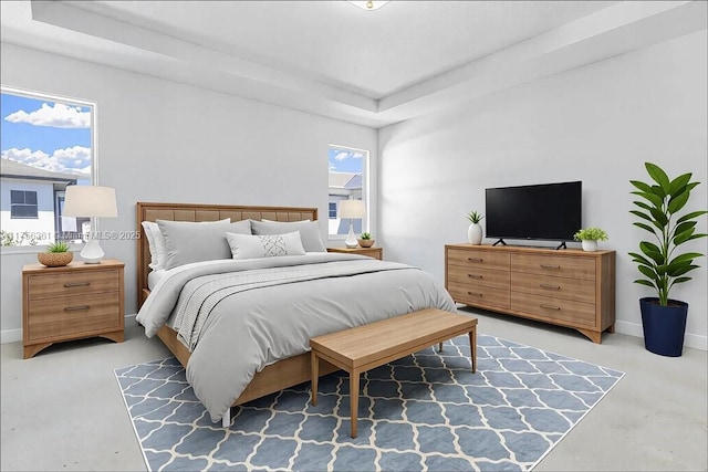 bedroom with a tray ceiling, baseboards, and concrete flooring