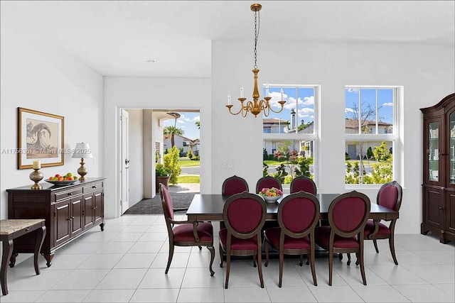 dining room featuring a notable chandelier and light tile patterned flooring