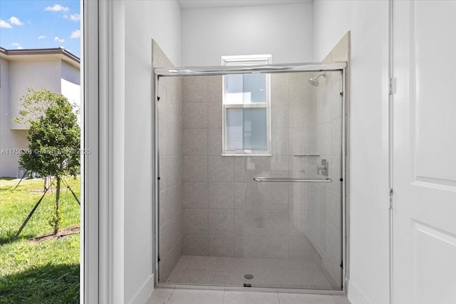 bathroom with a shower stall and a healthy amount of sunlight