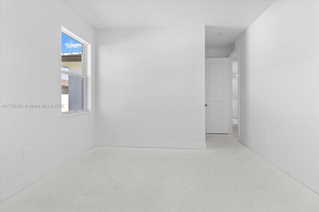 interior space featuring baseboards, visible vents, and concrete flooring