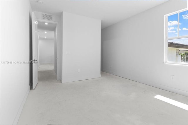 unfurnished bedroom featuring visible vents and concrete flooring