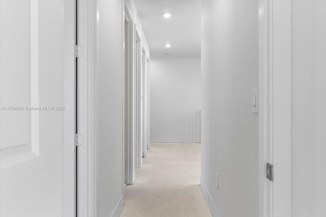 corridor featuring recessed lighting and baseboards