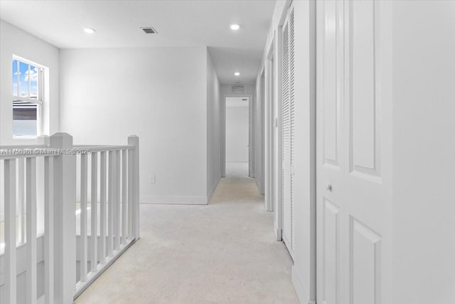 hallway featuring recessed lighting, an upstairs landing, visible vents, and baseboards