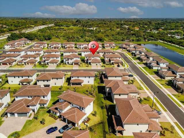 birds eye view of property with a residential view and a water view