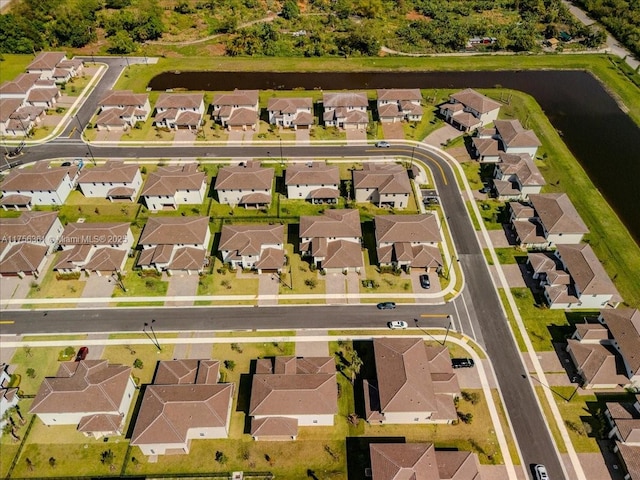 drone / aerial view with a residential view and a water view