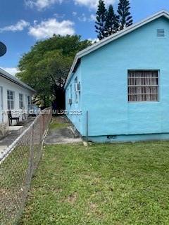 2156 NW 32nd St, Miami, FL 33142 - view of side of property featuring a yard and fence