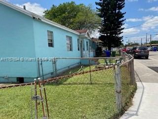2156 NW 32nd St, Miami, FL 33142 - view of home's exterior with a yard and fence