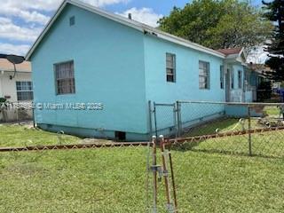 2156 NW 32nd St, Miami, FL 33142 - view of property exterior with a yard and fence