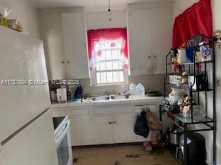 2156 NW 32nd St, Miami, FL 33142 - kitchen featuring white cabinetry, light countertops, and white appliances