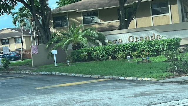 community / neighborhood sign with a yard