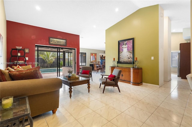 living area featuring light tile patterned floors, baseboards, and high vaulted ceiling