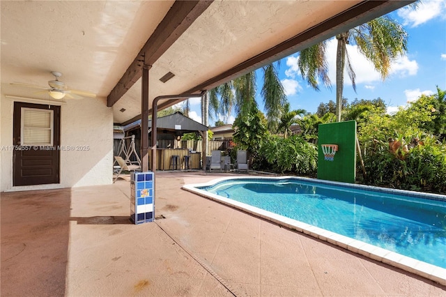 view of pool with a fenced in pool, a patio, ceiling fan, and fence