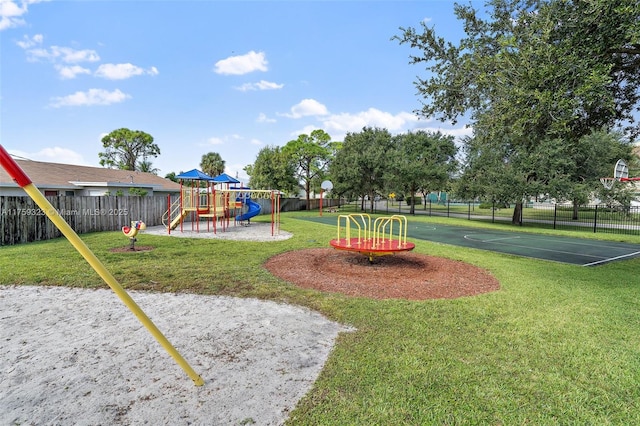 community playground with a lawn, community basketball court, and fence