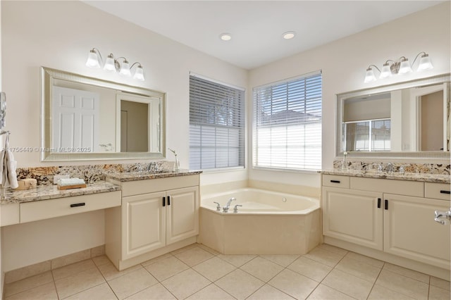 full bathroom with a sink, a garden tub, two vanities, and tile patterned flooring