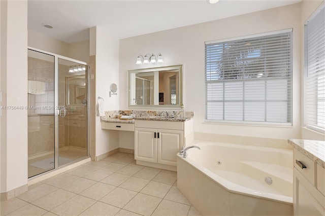 bathroom with vanity, baseboards, a whirlpool tub, a shower stall, and tile patterned floors