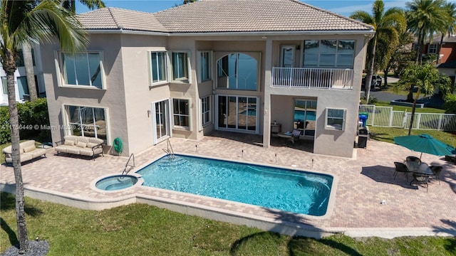 back of property with fence, an outdoor living space, stucco siding, a tiled roof, and a patio area