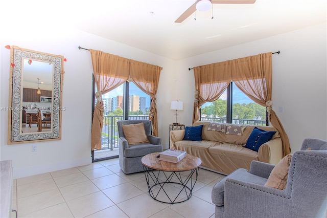 tiled living room with baseboards and a ceiling fan