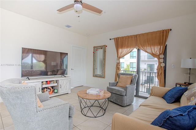 living area with light tile patterned floors, visible vents, and a ceiling fan