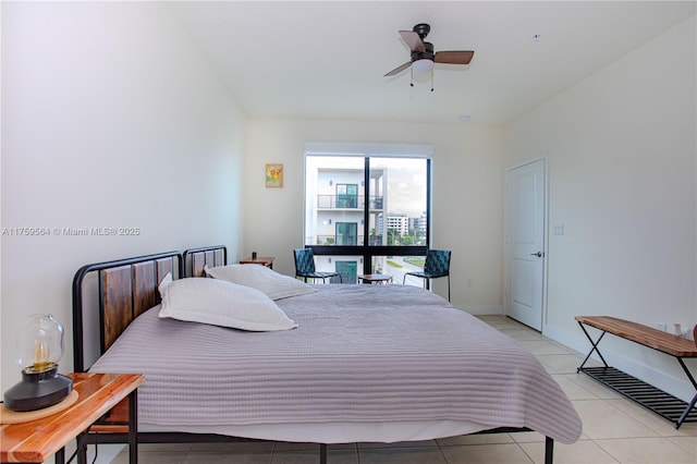 bedroom with light tile patterned floors, a ceiling fan, and baseboards