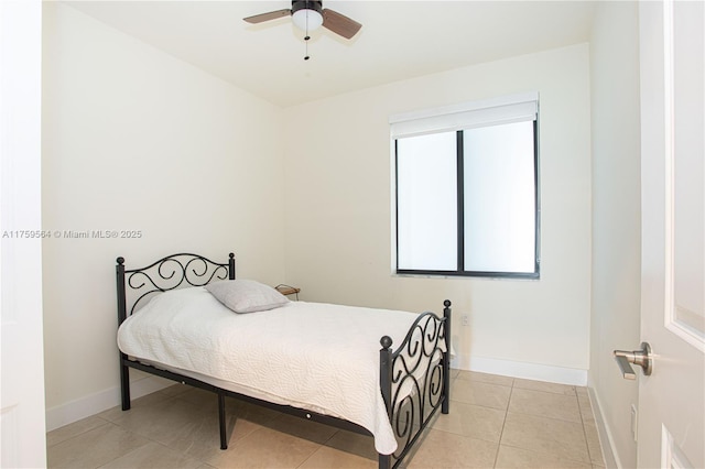 bedroom with a ceiling fan, baseboards, and light tile patterned floors