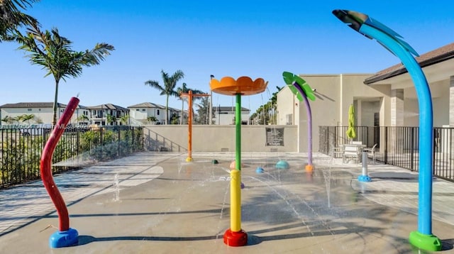 view of jungle gym featuring a residential view and fence