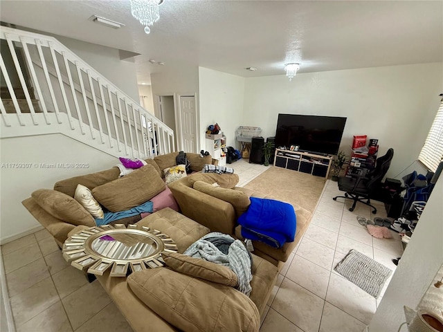 tiled living area with a textured ceiling and stairs